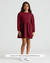 Girl in Girls Dark Maroon Long Sleeve Fleece Dress, white sneakers.