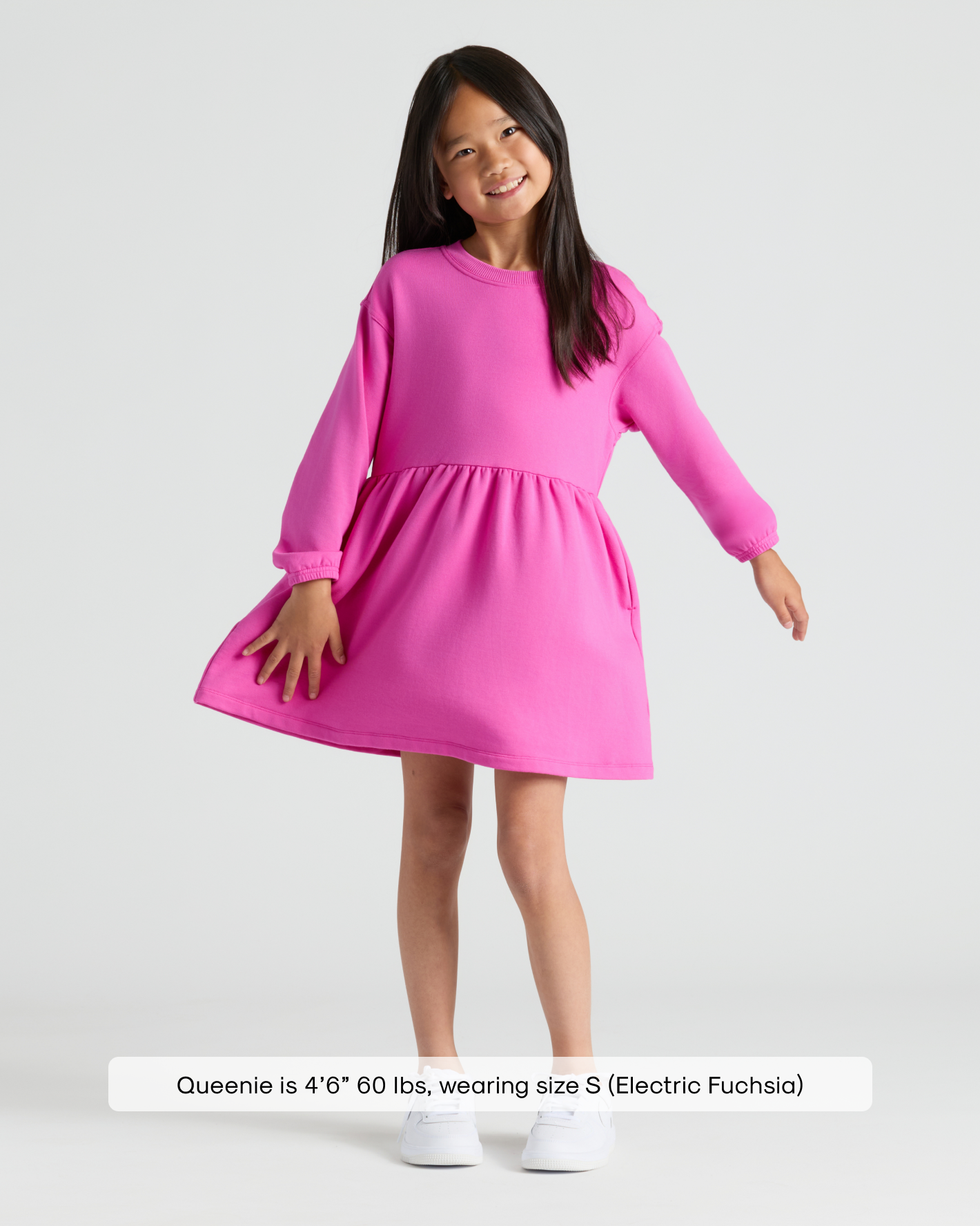 Girls Electric Fuchsia Long Sleeve Fleece Dress on young girl, white sneakers.