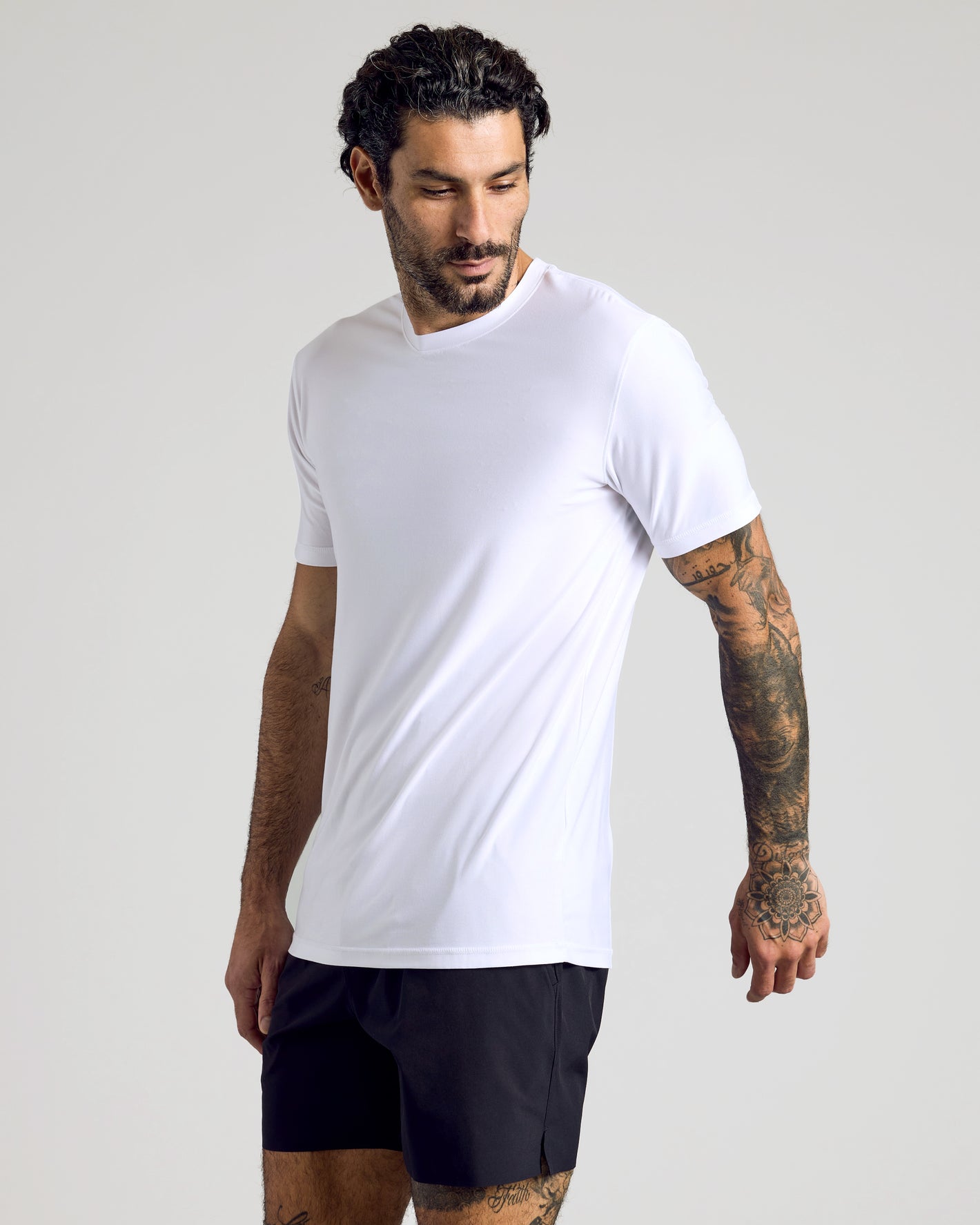 Man wearing Active Crew 3-Pack white performance tee and black shorts.