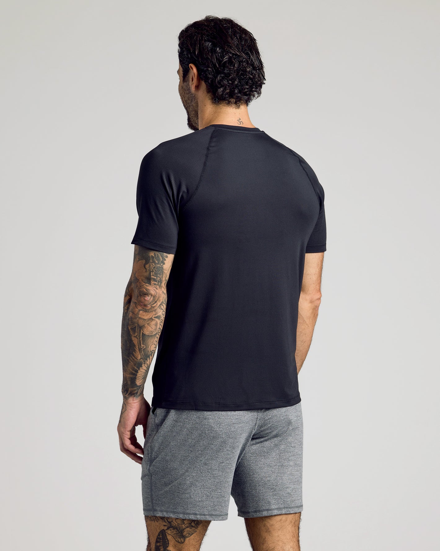 Man in Black Active Mesh Crew 6-Pack, showcasing back view and tattoos.