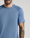 Fiord Active Mesh Crew on tattooed man, showcasing breathable, textured fabric.