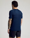 Man in navy Mesh Active Raglan Tee and black athletic shorts.