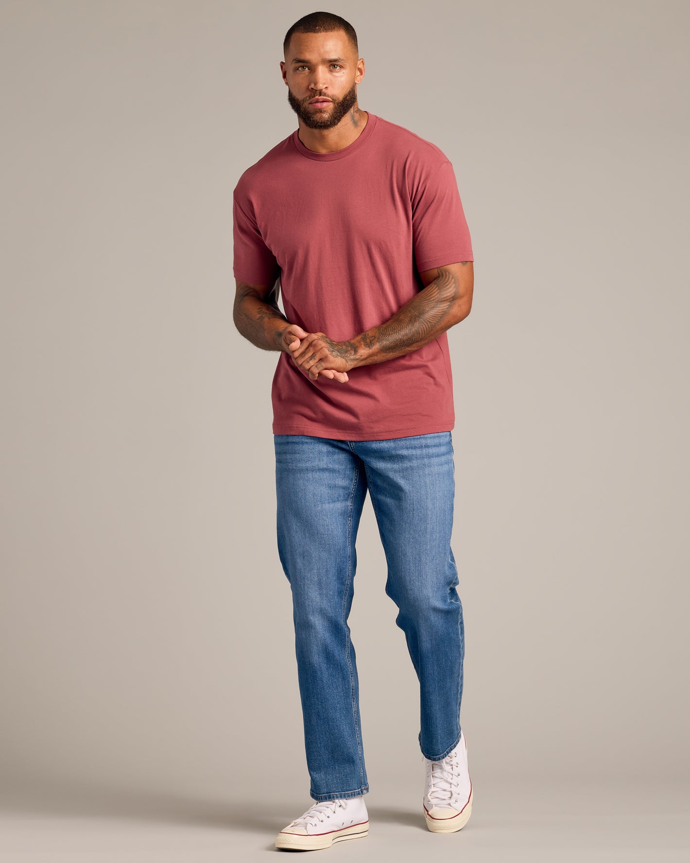 Model wearing Rustic Apple Short Sleeve Crew Neck with blue jeans and sneakers.