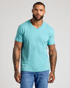 Man wearing Dark Heather Oceanic Classic V-Neck with jeans, tattoos visible.
