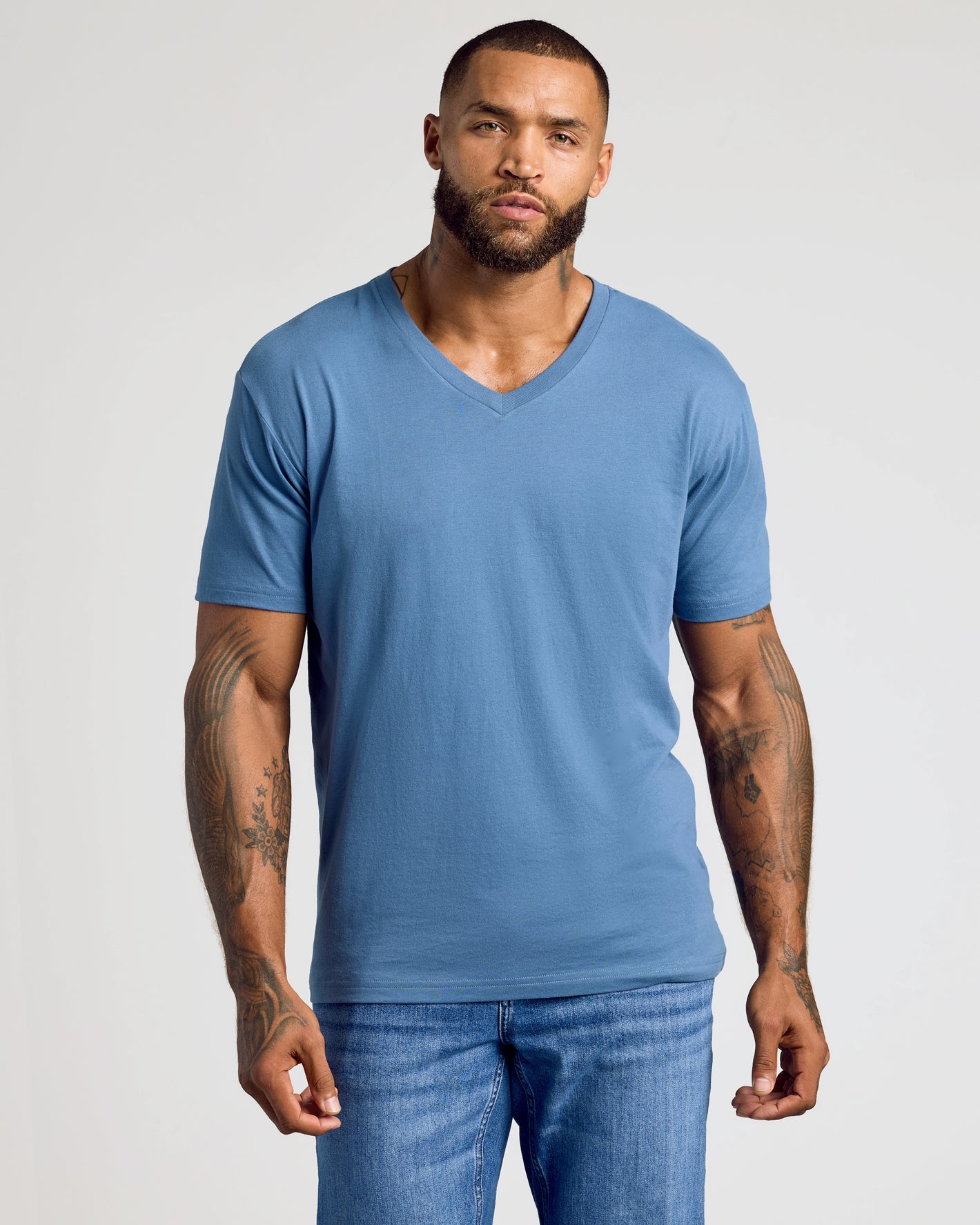 Fiord Classic V-Neck worn by tattooed man with beard.