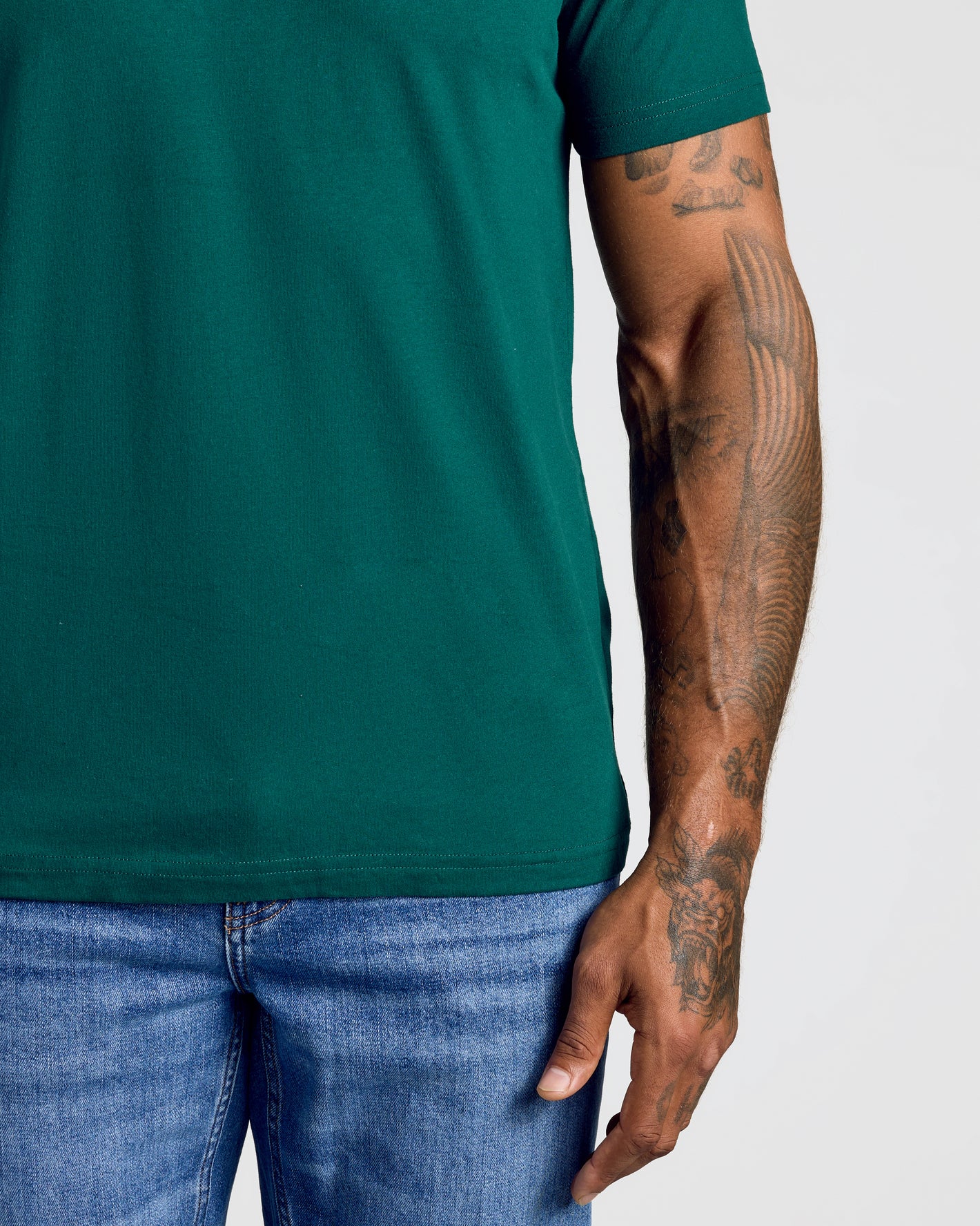 Person wearing the Viridian Classic V-Neck with tattooed forearm.