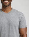 Man wearing a gray t-shirt against a plain background