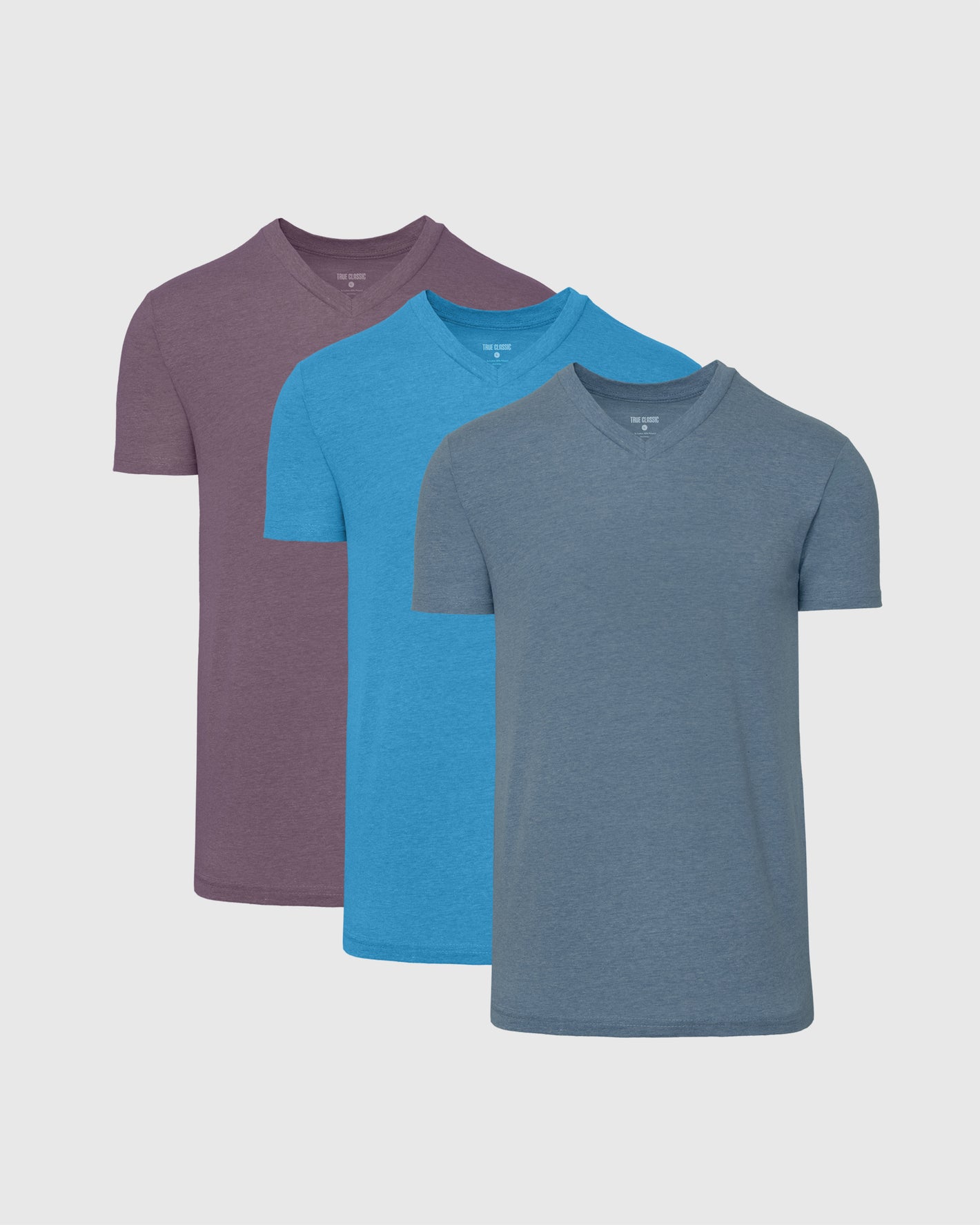 Limited Seasonal Classic V-Neck 3-Pack: Muted purple, sky-blue, slate-grayish-blue shirts.