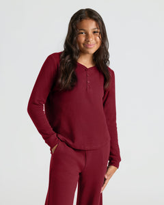 True ClassicGirl in Girls Dark Maroon Waffle Long Sleeve Henley & Waffle Leg Pants, smiling.