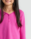 Child in Girls Electric Fuchsia Waffle Long Sleeve Henley, smiling.