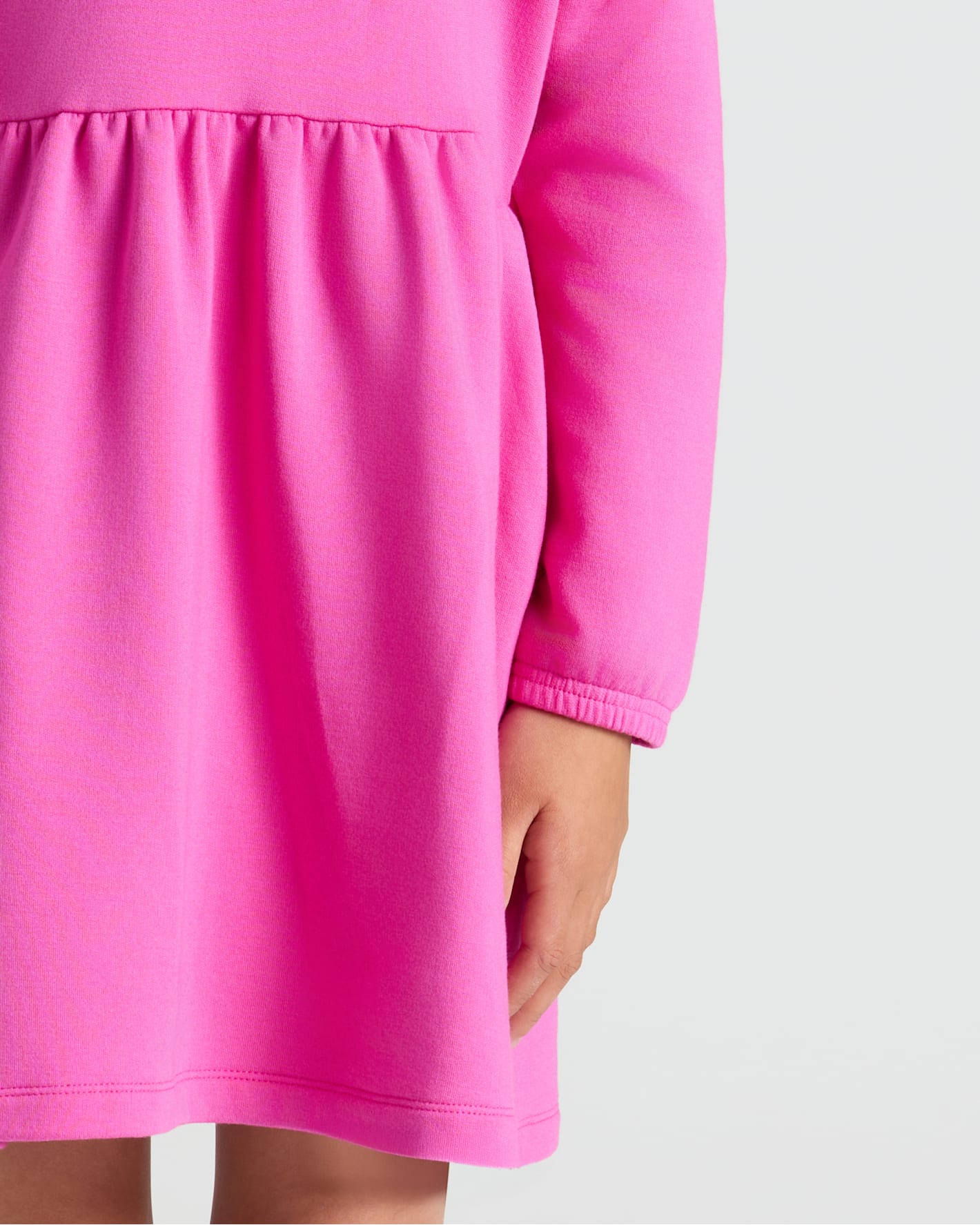 Girls Electric Fuchsia Long Sleeve Fleece Dress with gathered waist and cozy fit.