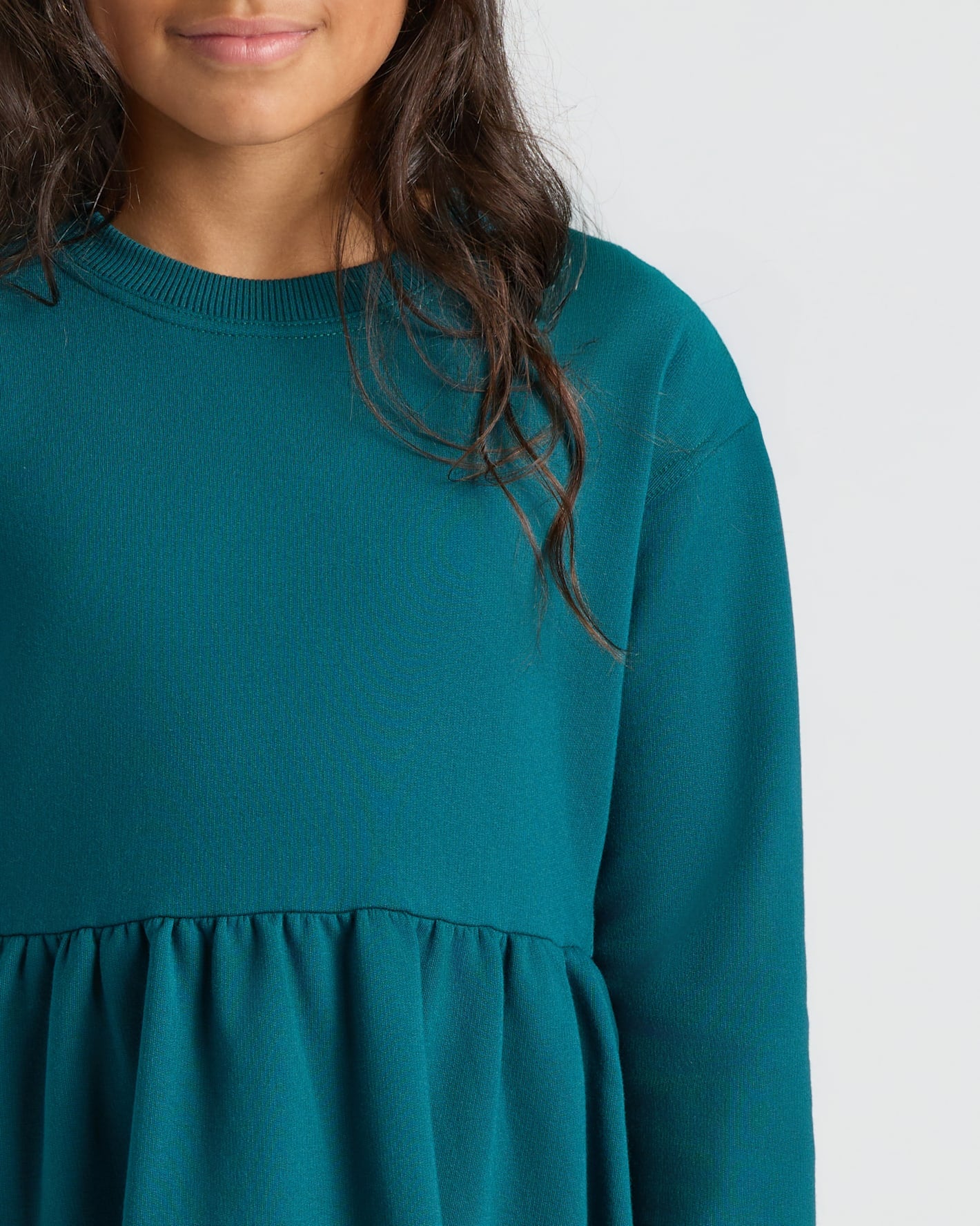 Girls Deep Emerald Long Sleeve Fleece Dress with peplum waist, cozy fit.