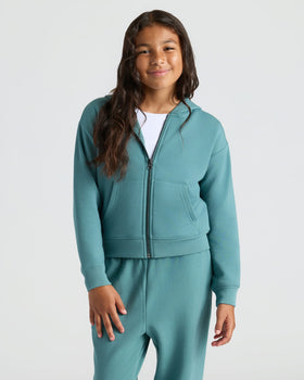 Girl wearing teal hoodie, featuring Girls Stormcloud Cropped Boxy Crew Neck Tee.