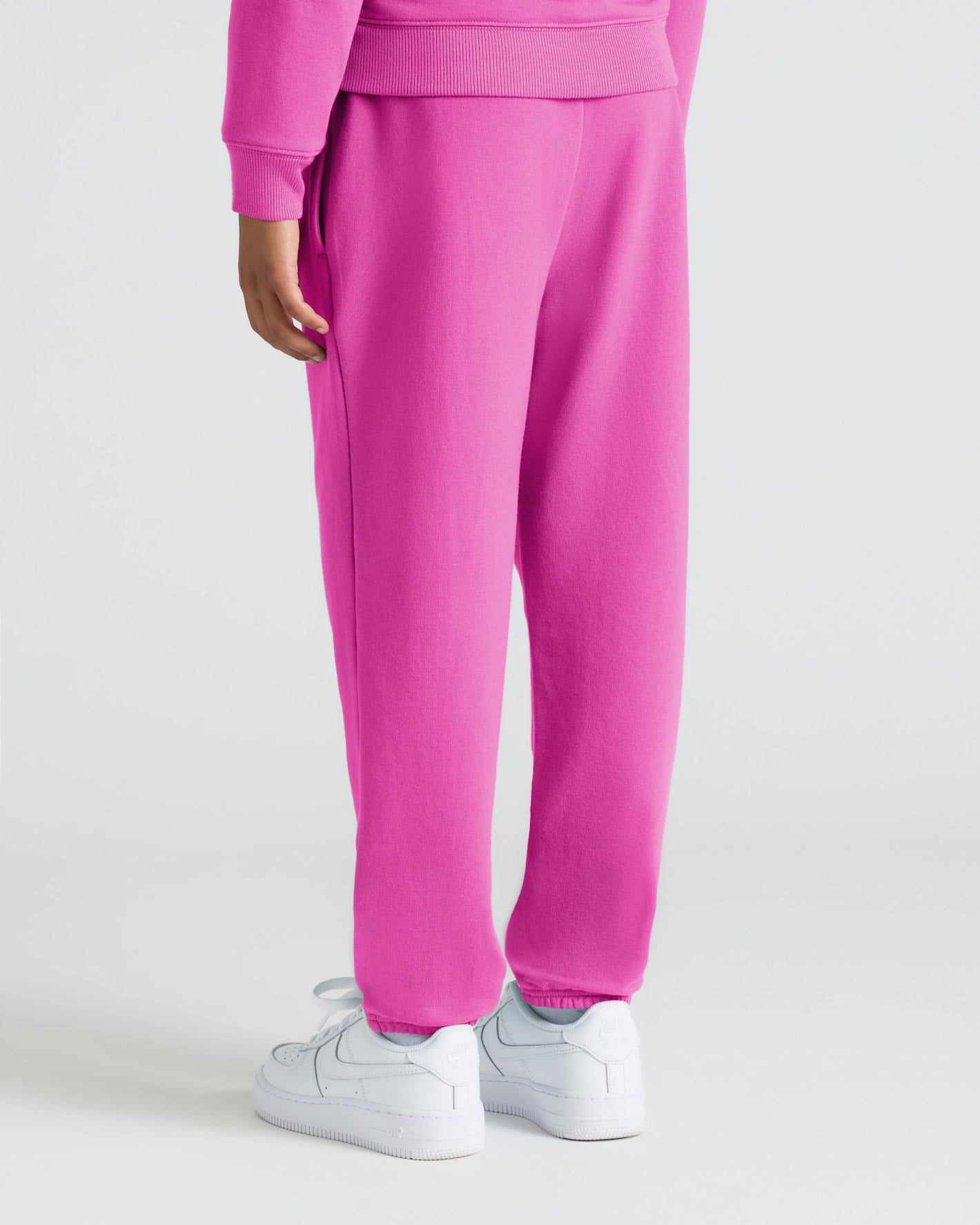 Girls Electric Fuchsia Joggers with white sneakers, showcasing relaxed fit.
