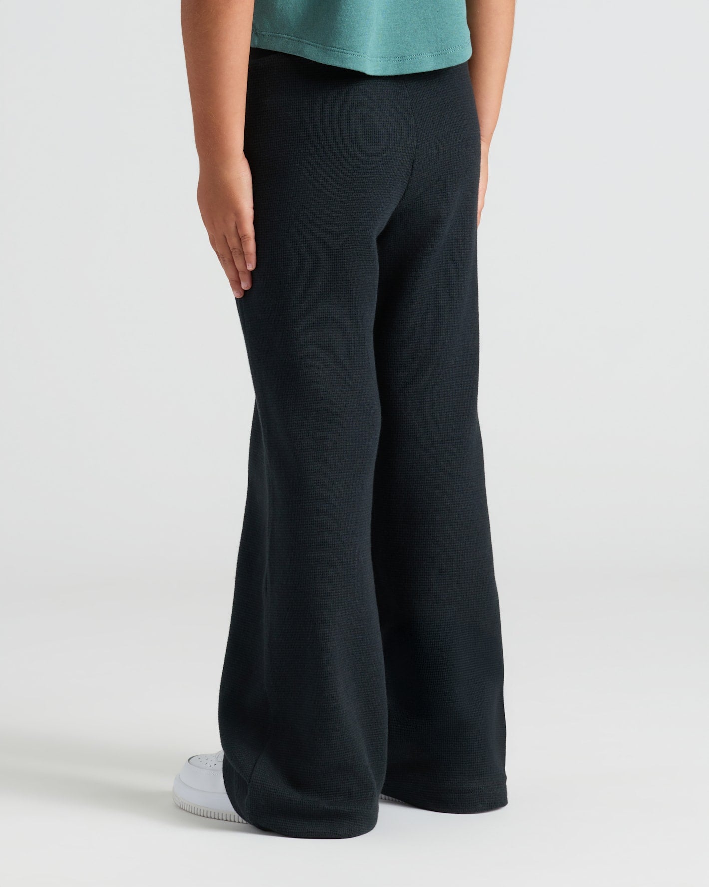 Girls Waffle Wide Leg Pants 3-Pack with black flared pants and sneakers.
