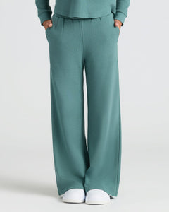 True ClassicGirls Stormcloud Waffle Wide Leg Pants with pockets and white sneakers.