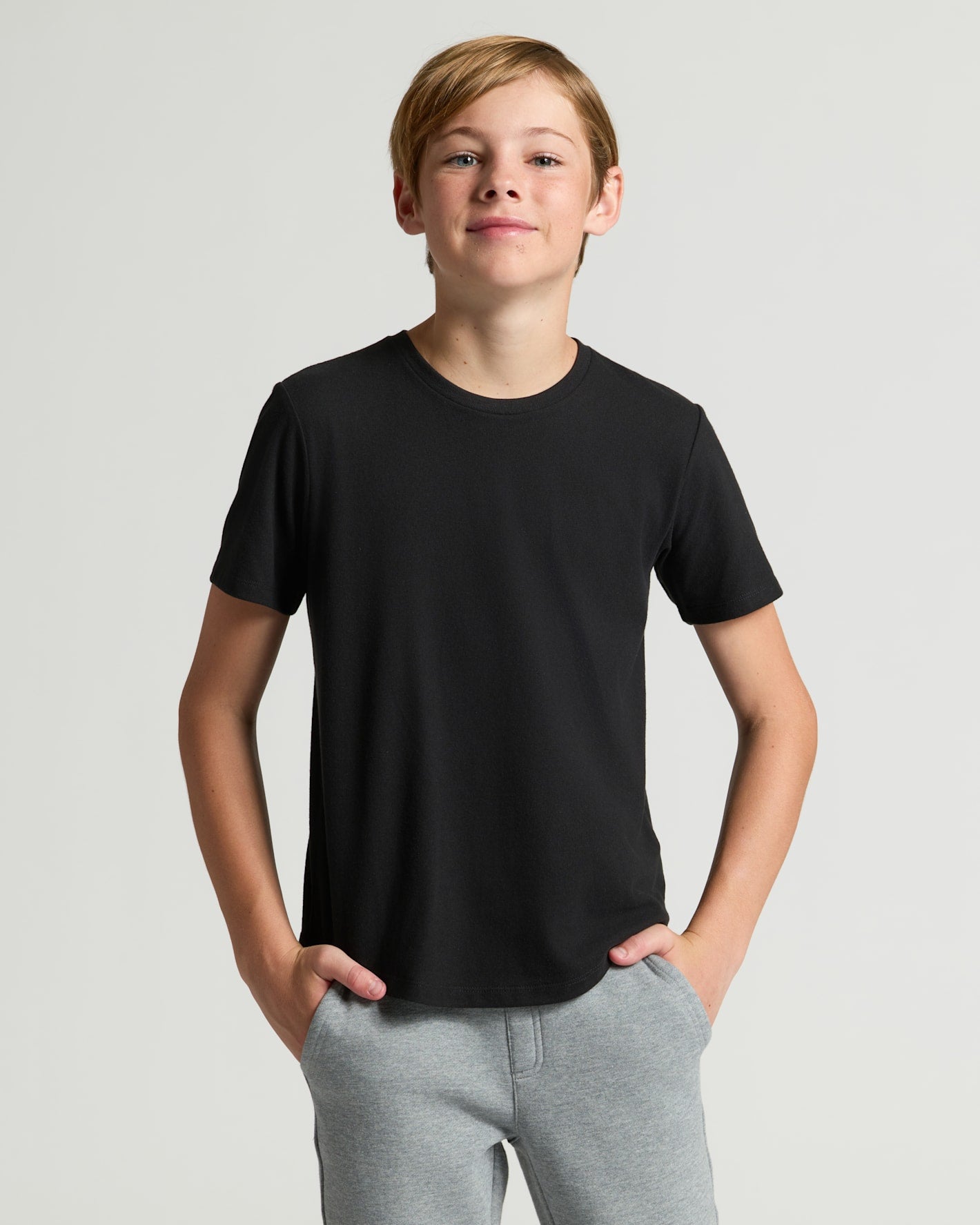 Teen boy modeling Boys' Classic Curved Hem Crew Neck 6-Pack.