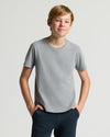 Boy wearing Boys' Heather Gray Classic Curved Hem Crew Neck with hands in pockets.