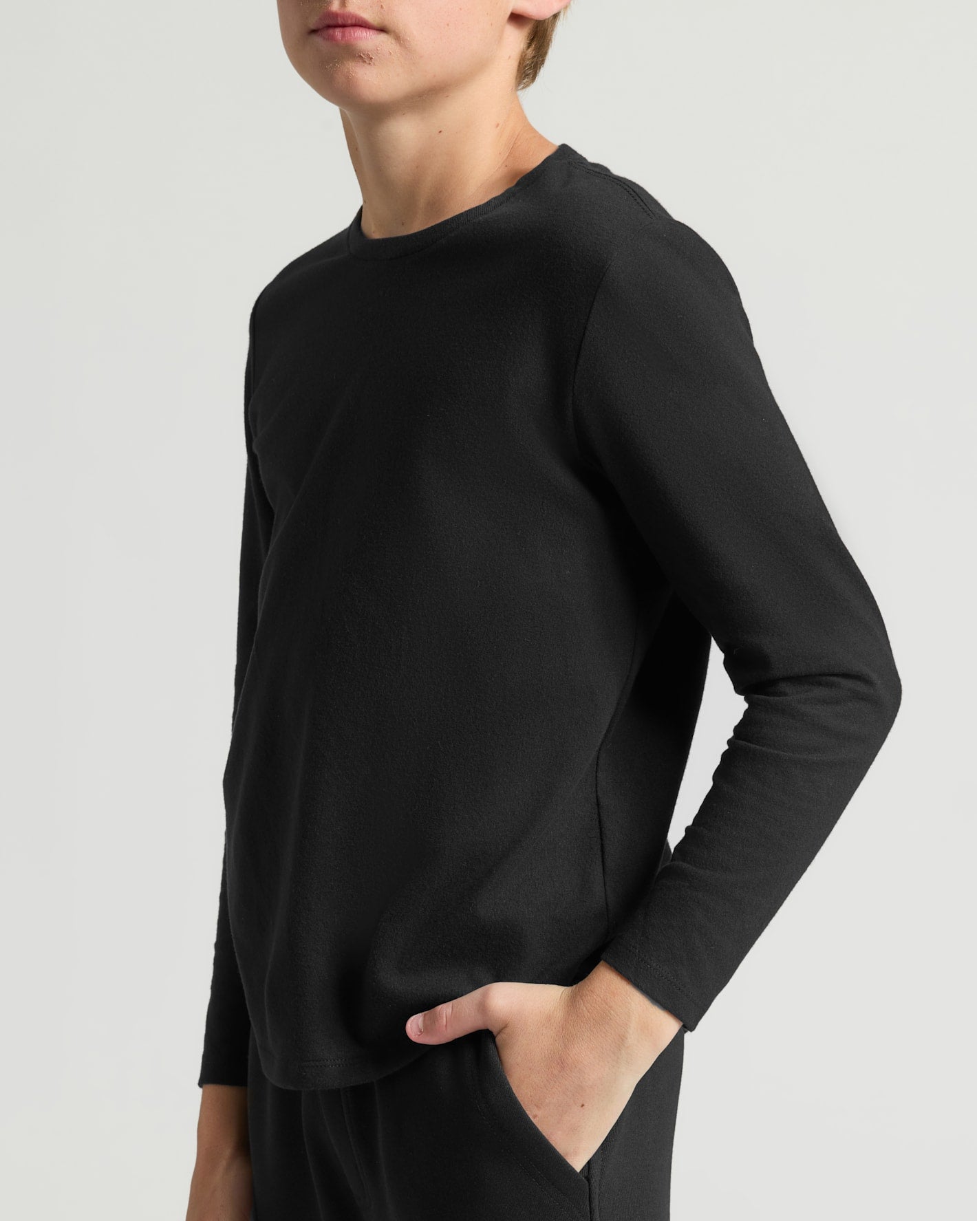 Teen wearing Boys' Classic Long Sleeve Curved Hem Crew Neck.