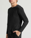 Boys' Classic Long Sleeve Curved Hem Crew Neck in black, hand in pocket.