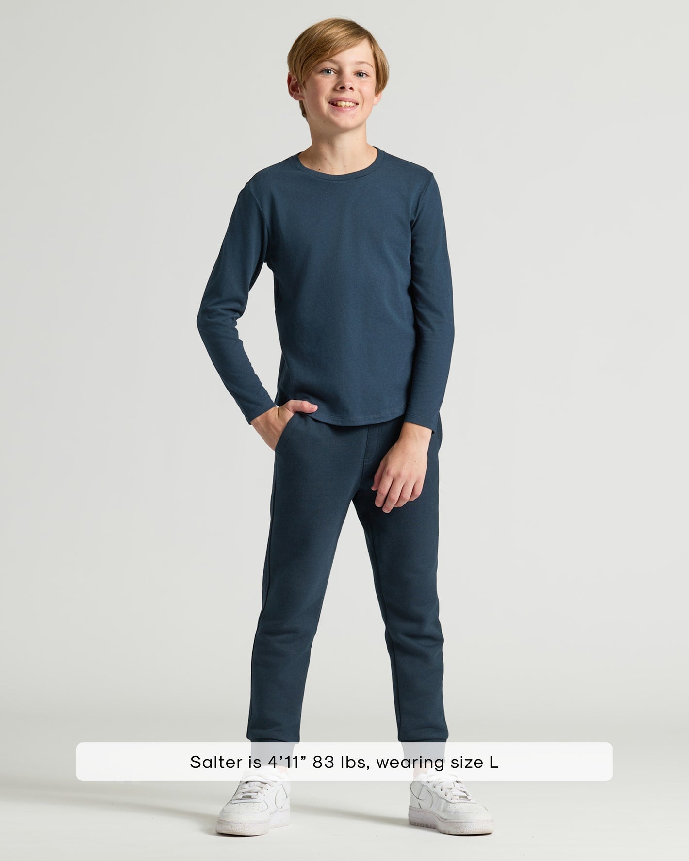 Boy wearing Boys' Navy Classic Long Sleeve Curved Hem Crew with joggers.