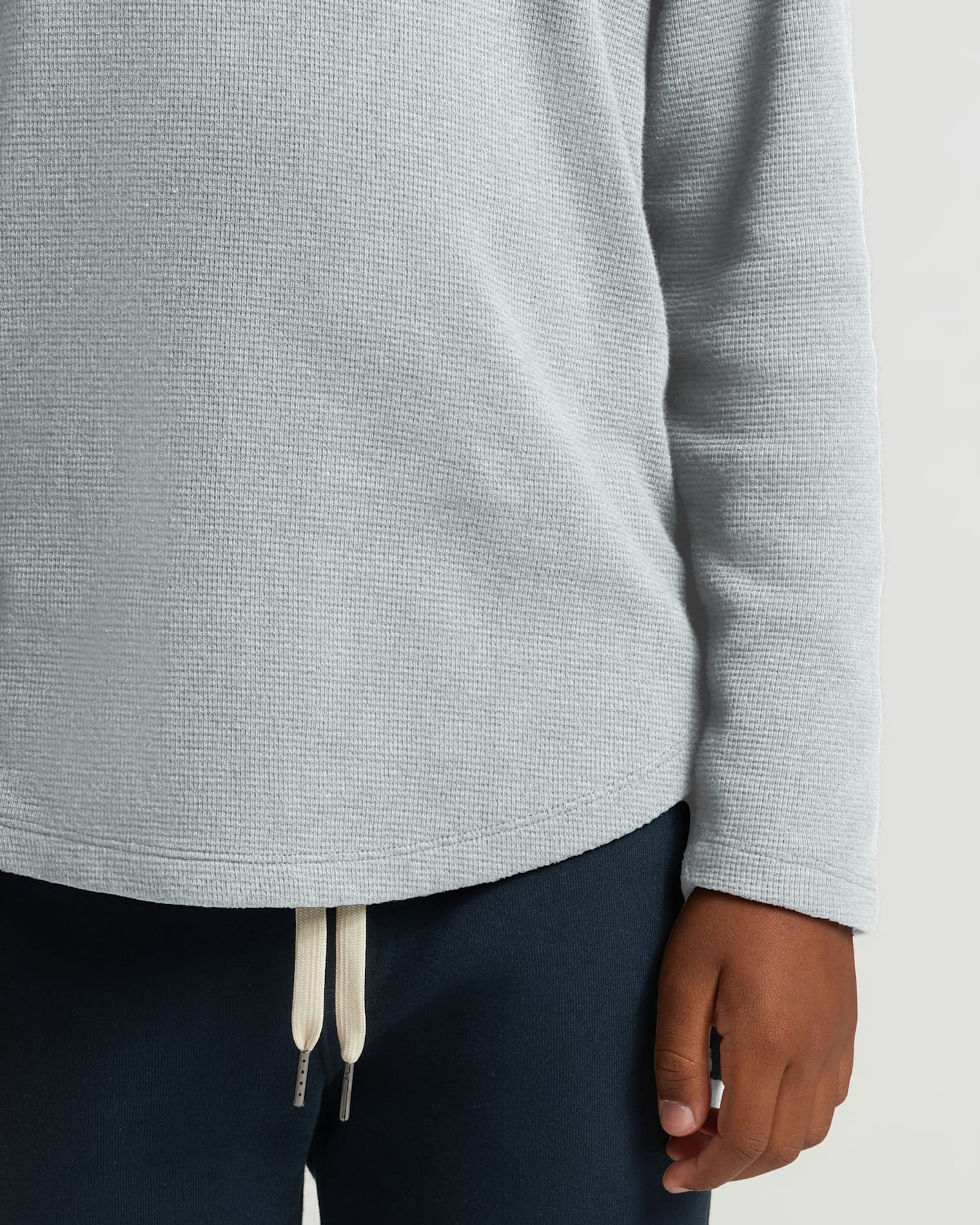 Boys' Waffle Long Sleeve Henley showcased with navy sweatpants.