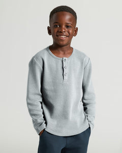 True ClassicBoy in Boys' Waffle Long Sleeve Henley, smiling, hands in pockets.
