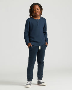 True ClassicBoys Navy Long Sleeve Waffle Henley on smiling boy with dreadlocks.