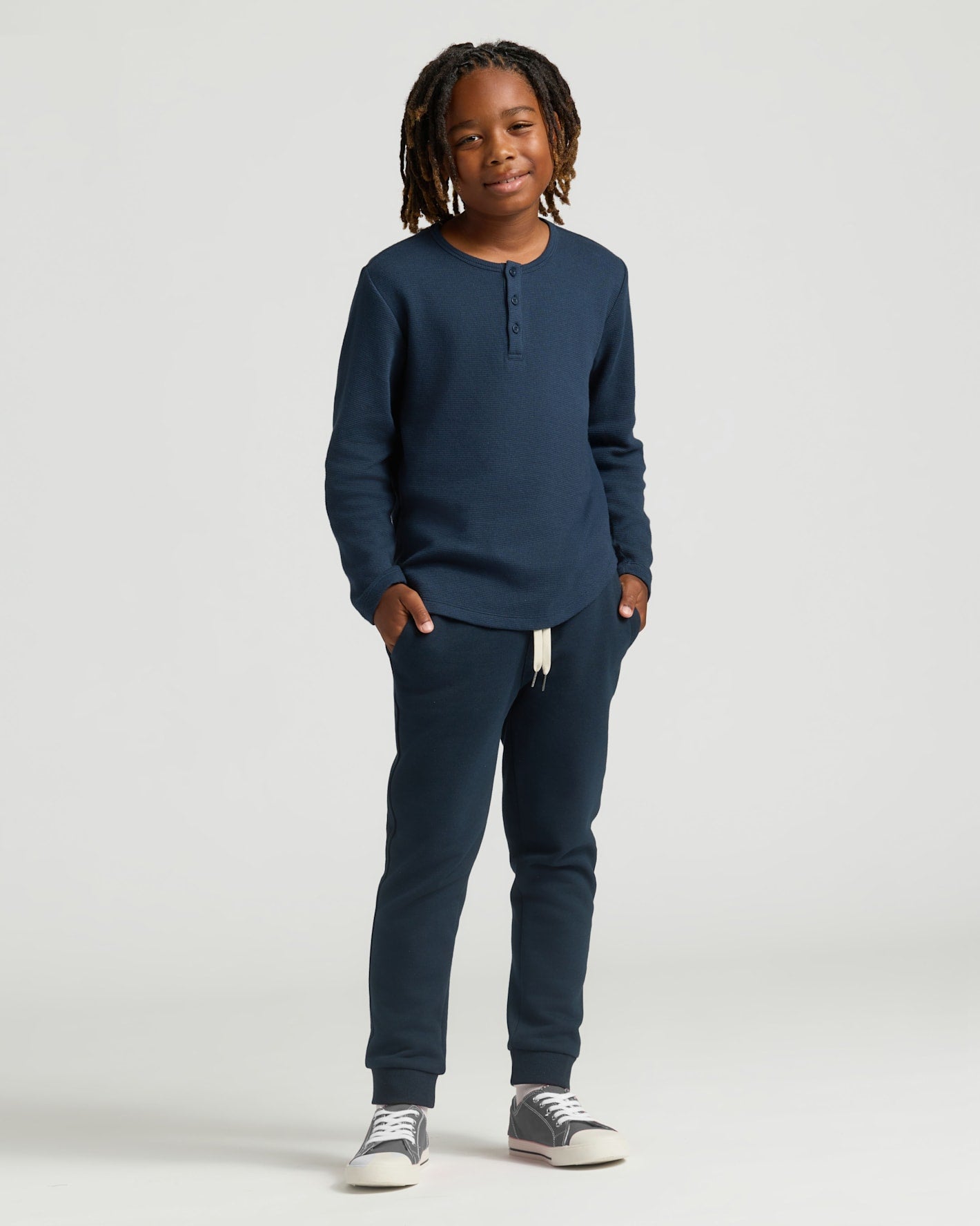 Boys Navy Long Sleeve Waffle Henley on smiling boy with dreadlocks.