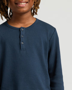 True ClassicClose-up of person wearing Boys' Waffle Long Sleeve Henley.