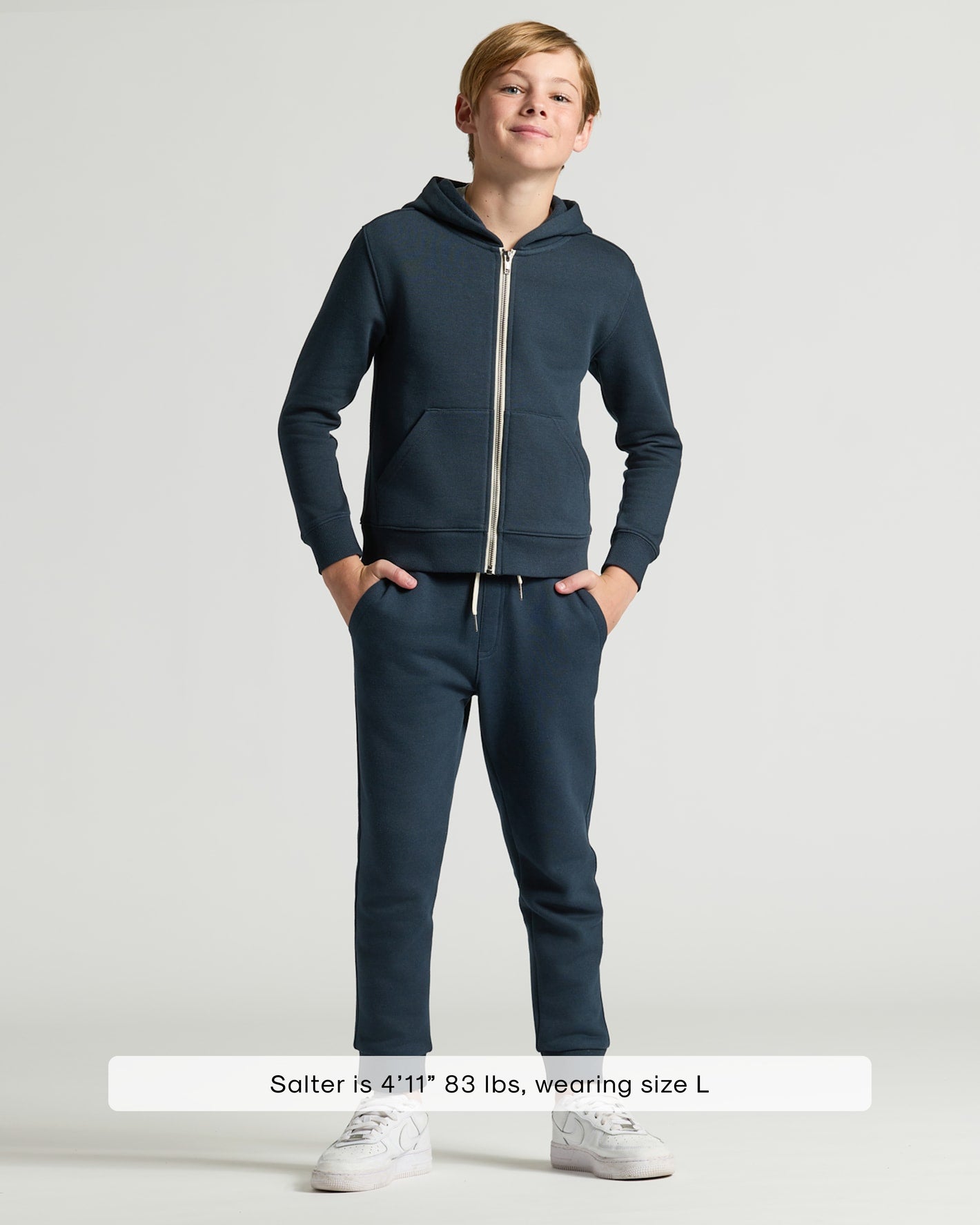 Boy wearing Boys' Navy Fleece Full Zip Hoodie with matching joggers.