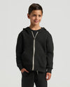 Boy wearing Boys' Black Fleece Full Zip Hoodie, smiling slightly.
