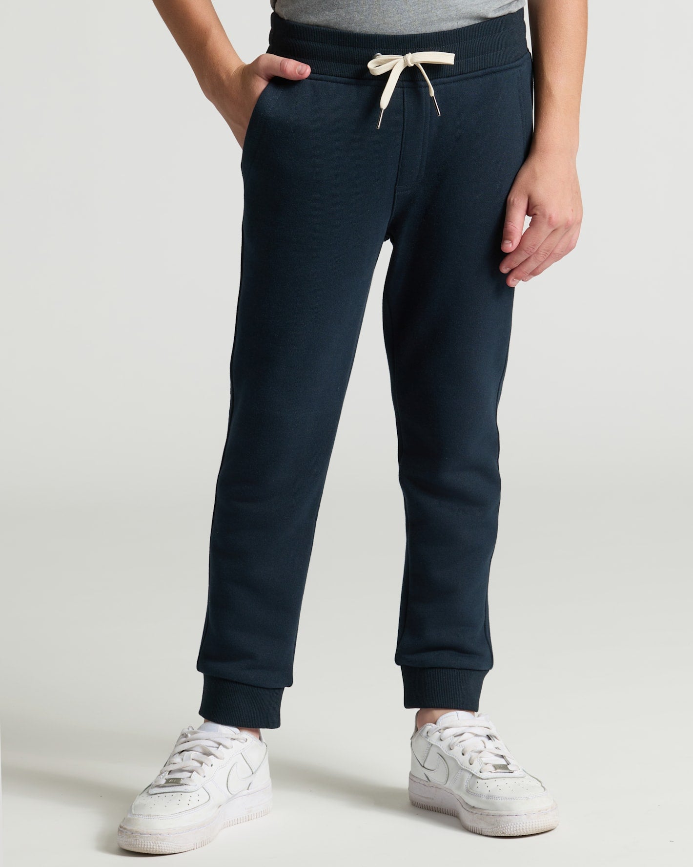 Boys' Black & Navy Fleece Joggers 2-Pack with white sneakers.
