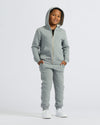 Boy wearing Boys' Medium Heather Gray Fleece Jogger with hoodie and sneakers.