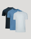Three short-sleeve shirts in navy, blue, and light blue on a gray background