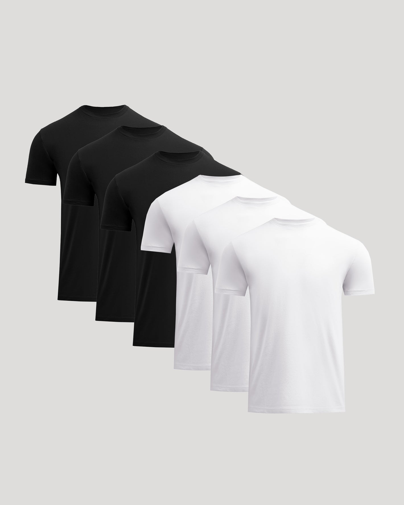 Set of black and white polo shirts on a light gray background