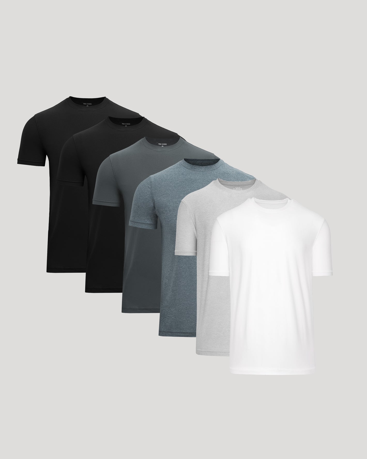 Set of four men's t-shirts in black, gray, blue, and white on a light gray background