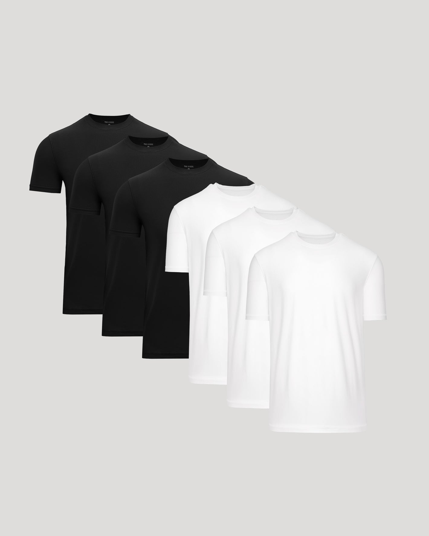 Set of black and white t-shirts on a light gray background