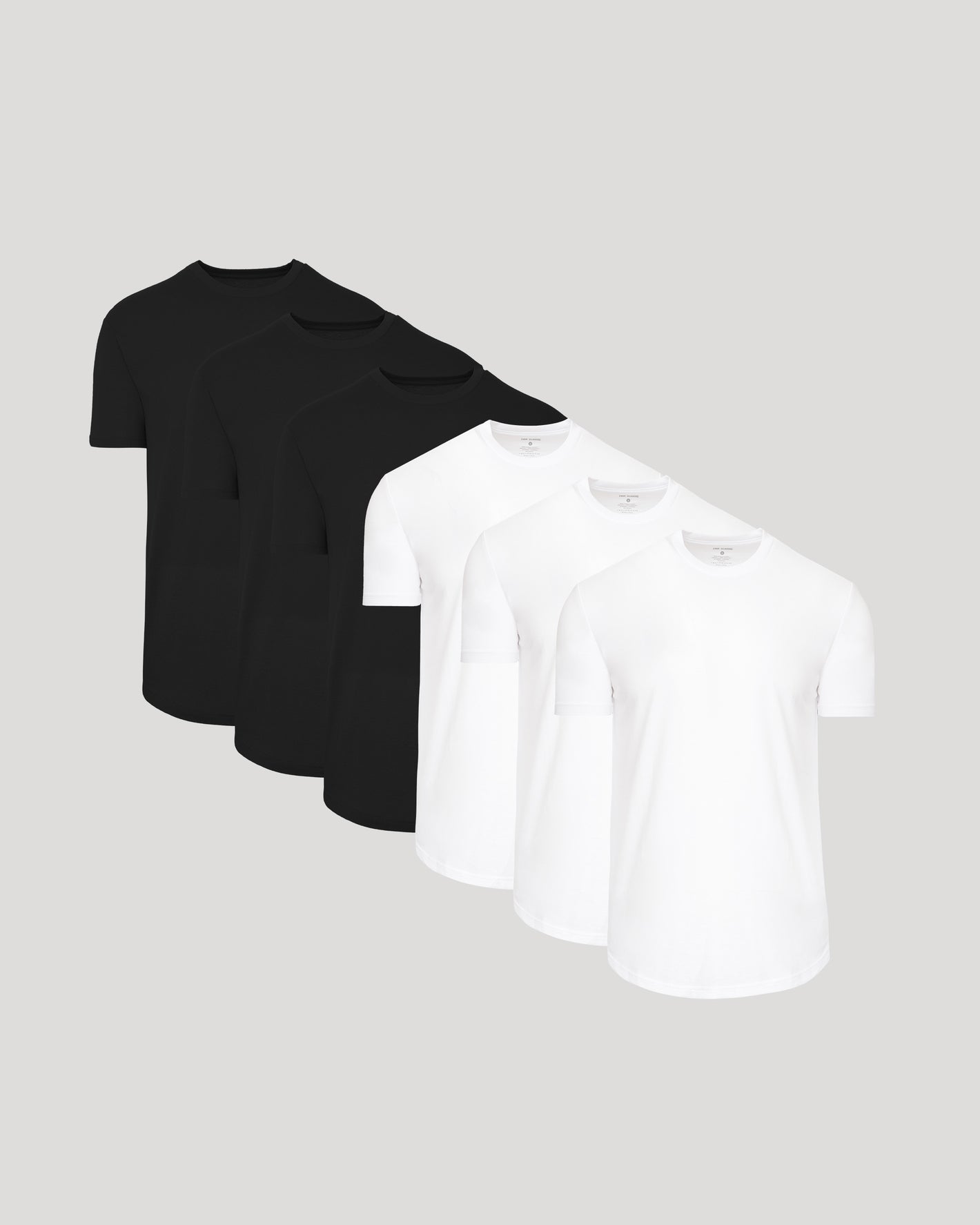 Three black t-shirts and three white t-shirts on a light gray background