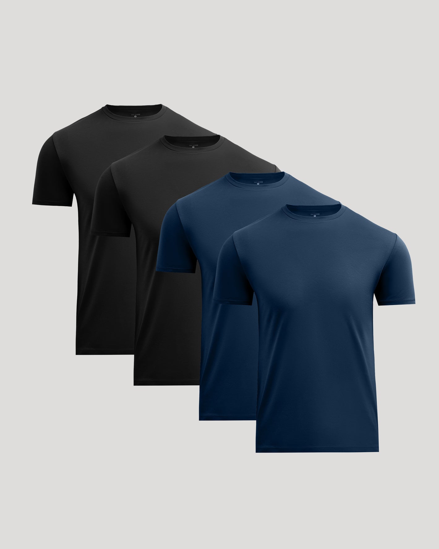 Three short-sleeve crew-neck t-shirts in black, dark gray, and navy blue, arranged in a staggered overlapping layout against a solid light gray background.