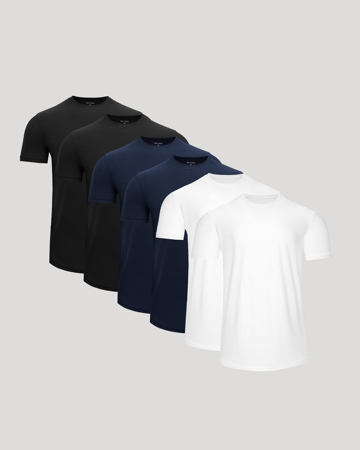 A set of men's basics featuring the Active Curved Hem Crew Tee - Men's Moisture Wicking Performance T-Shirt in black, navy blue, and white colors, designed for comfort and performance.