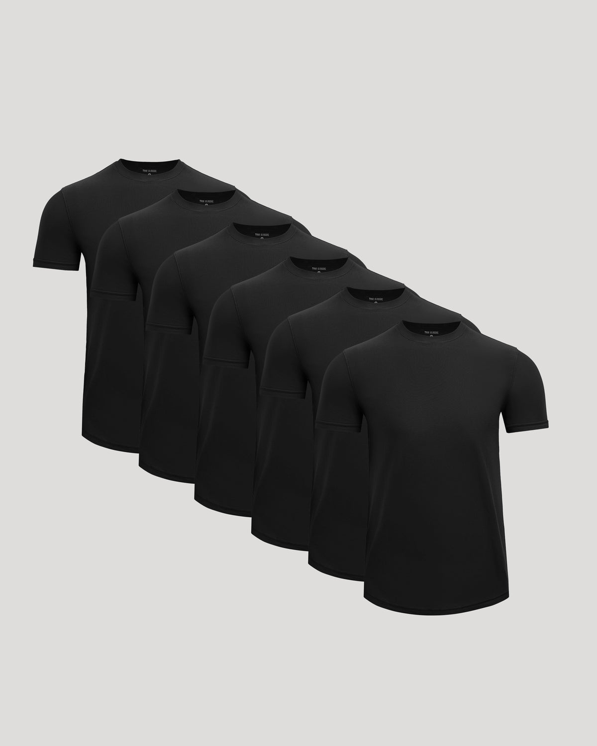 Six black Active Curved Hem Crew Tee - Men's Moisture Wicking Performance T-Shirts arranged in a staggered formation on a neutral background.