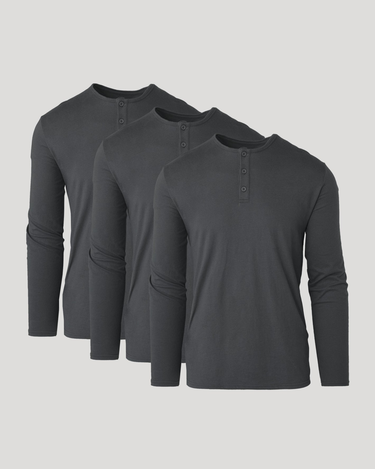 Three dark gray long-sleeve henley shirts on a light gray background