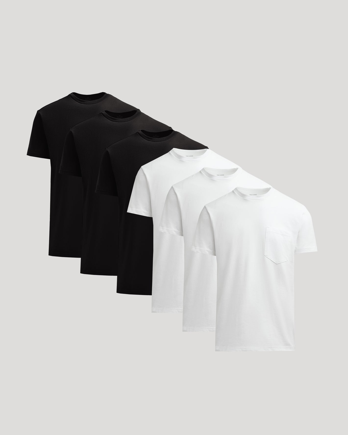 Three black t-shirts and three white t-shirts on a light gray background