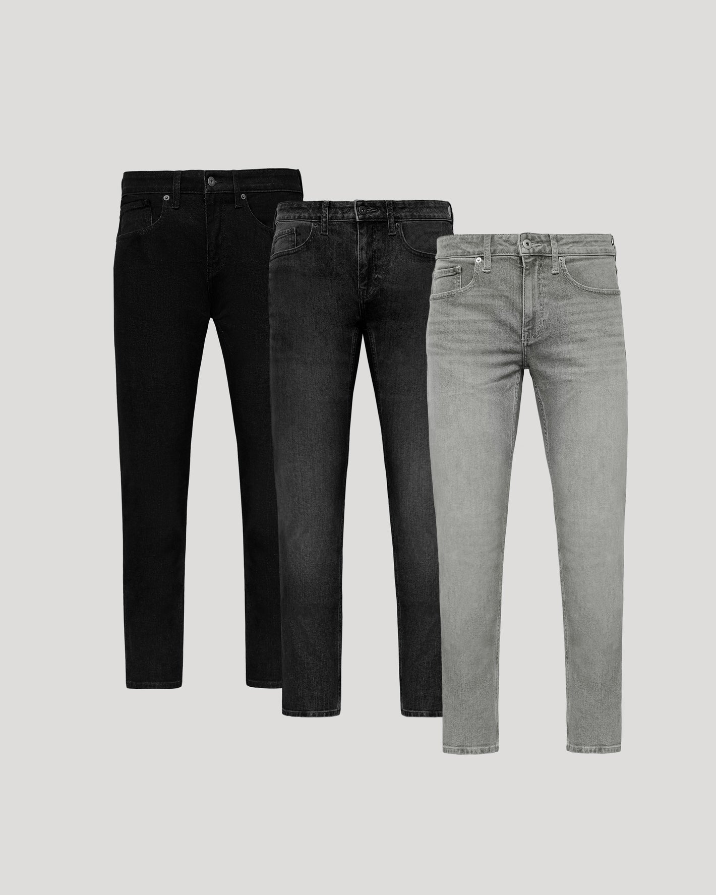 Three pairs of jeans in black, dark gray, and light gray on a light gray background