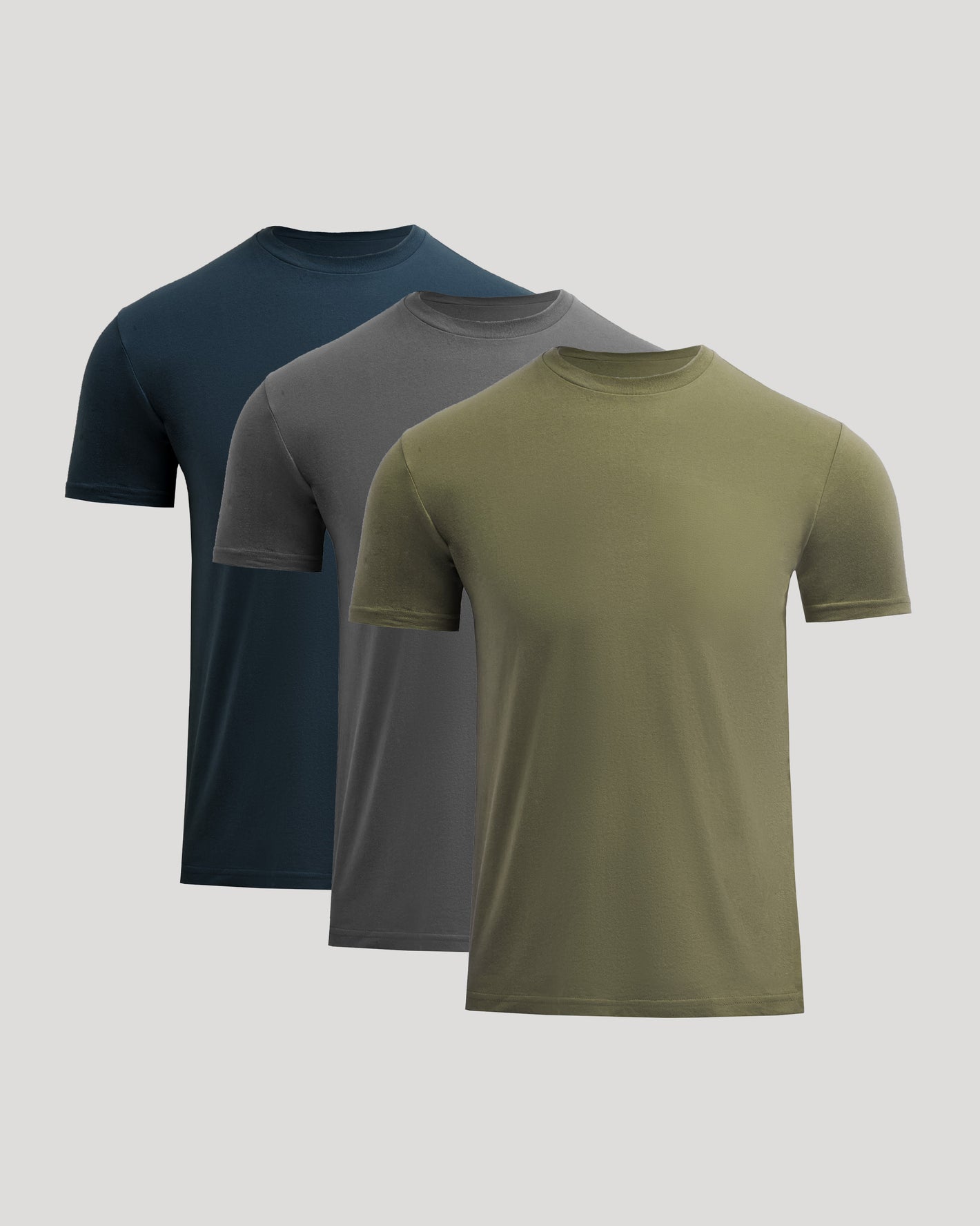 Three t-shirts in navy, gray, and green on a light gray background