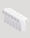 Multiple white t-shirts stacked on a light gray background
