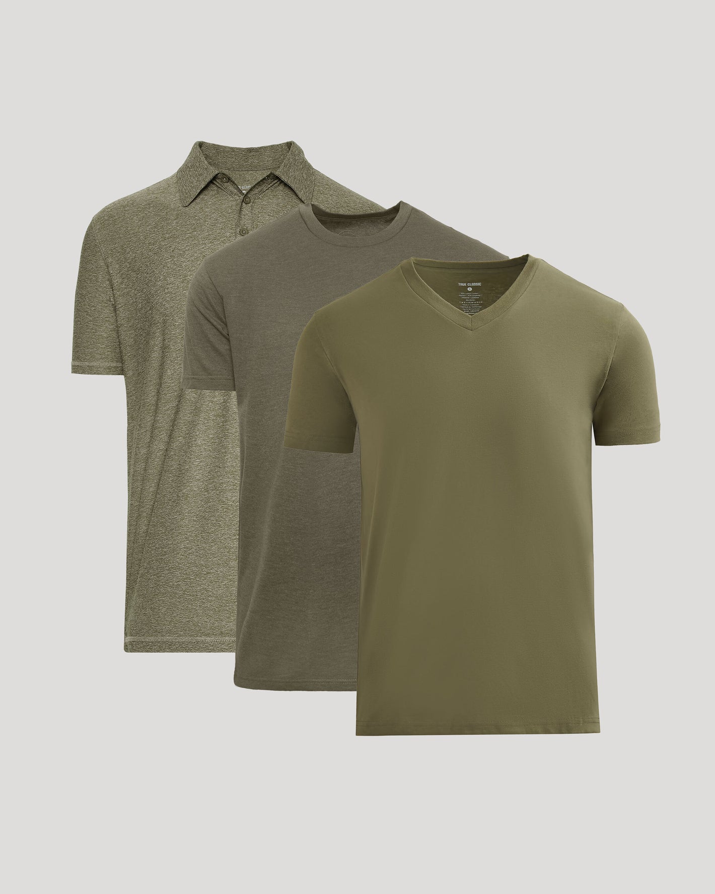 Three green shirts including a polo, a V-neck, and a short-sleeve t-shirt on a light gray background.