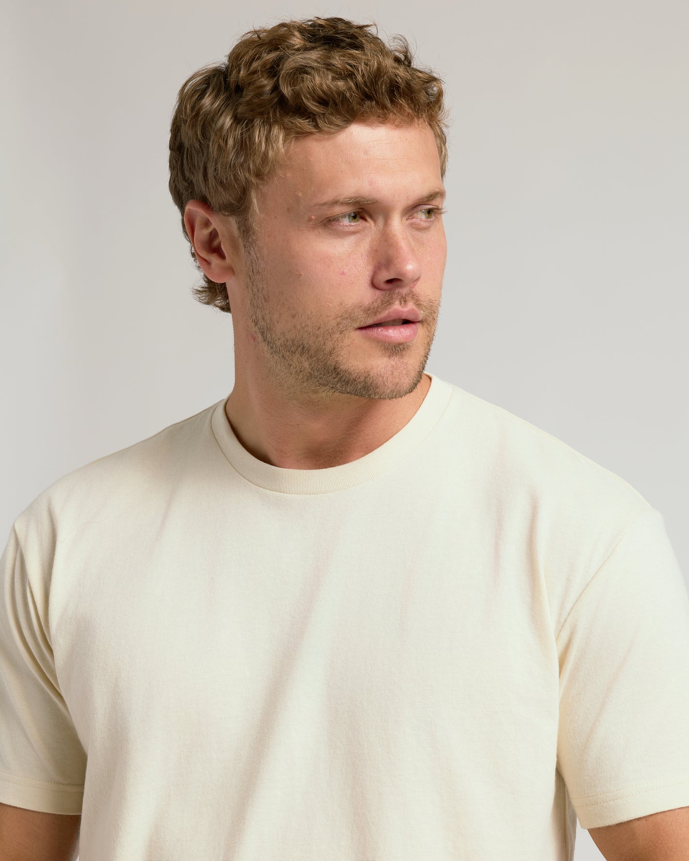 Young man wearing Alabaster Classic Crew Neck T-shirt.