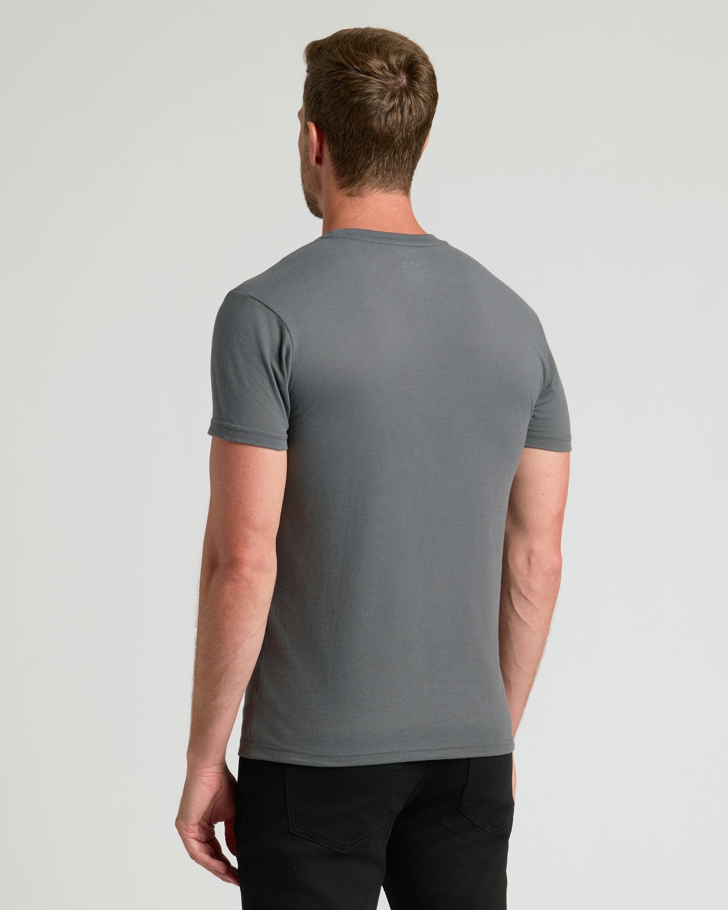 Man wearing Essentials Crews fitted gray T-shirt from the back.